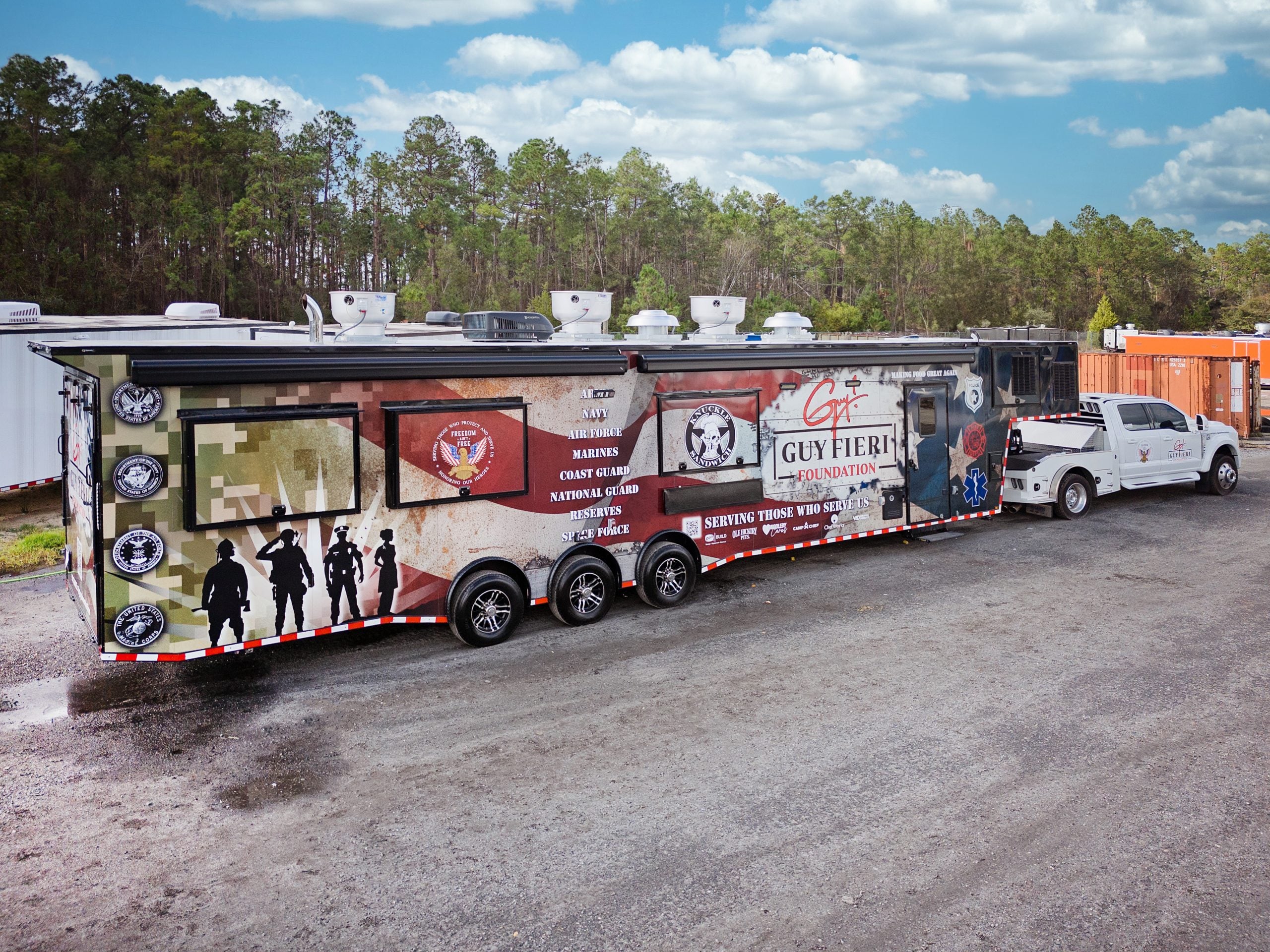 Aerial drone photograph of the Guy Fieri Foundation disaster relief kitchen deployment in Holmes County, Florida, showing the trailer set up